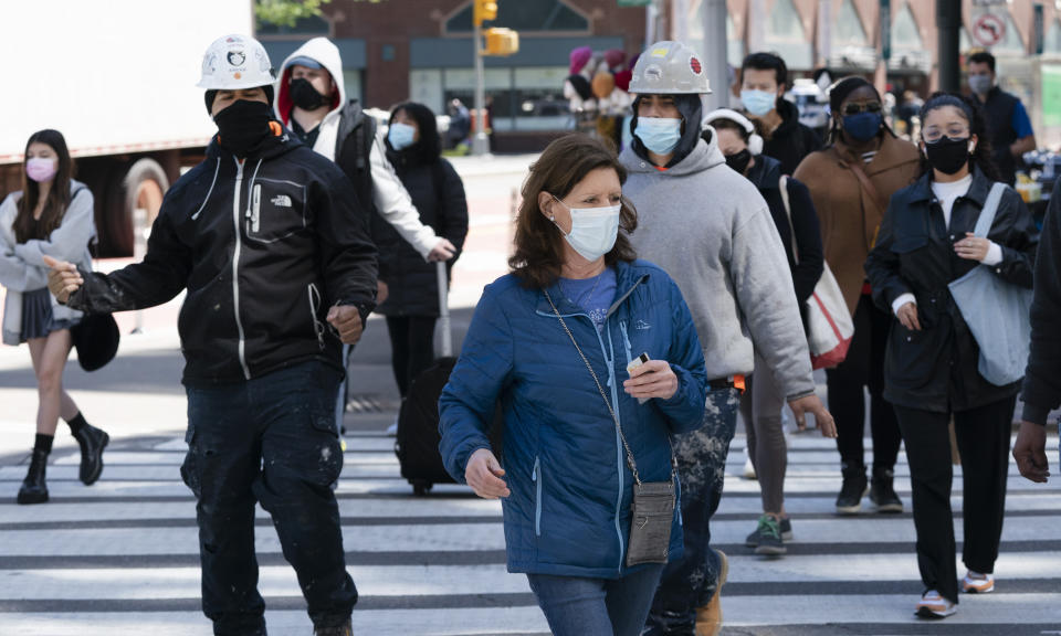 People walk on the street, Monday, April 26, 2021 in New York. The once-a-decade head count of the United States shows where the population grew during the past 10 years and where it shrank. New York will lose one seat in Congress as a result of national population shifts, according to census data released Monday. (AP Photo/Mark Lennihan)