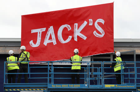 Workers unveil the branding at Tesco's new discount supermarket Jack's, in Chatteris, Britain, September 19, 2018. REUTERS/Chris Radburn