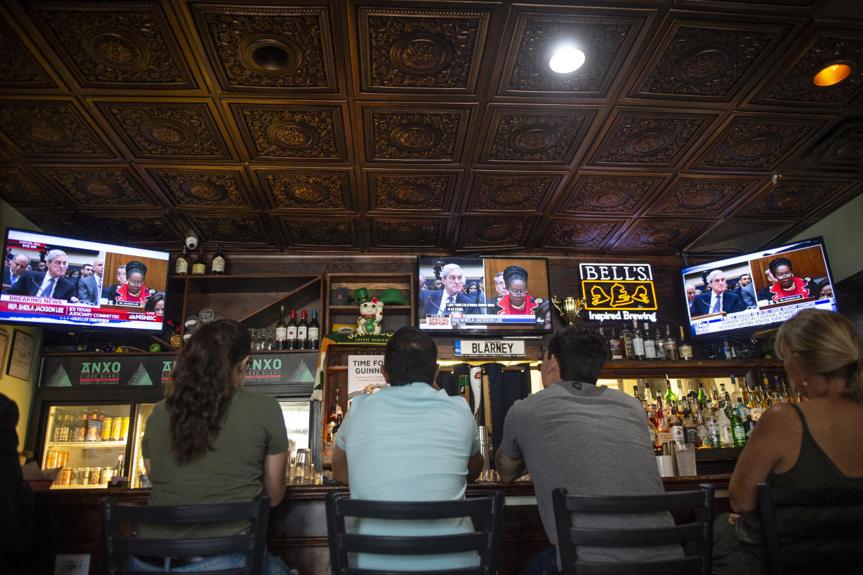 People watch former special counsel Robert Mueller testify before Congress at Duffys Irish Pub in Washington, D.C., on Wednesday. (Photo by Caroline Brehman/CQ Roll Call)