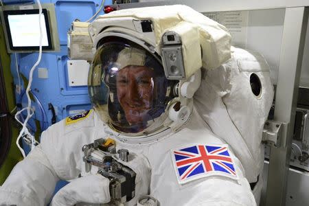 British astronaut Tim Peake poses in his spacesuit aboard the International Space Station on January 11, 2015. Peake became the first astronaut representing Britain to walk in space when he left the International Space Station (ISS) on Friday to fix a power station problem, generating huge interest back in his homeland. Picture taken January 11, 2015. REUTERS/NASA/Handout via Reuters