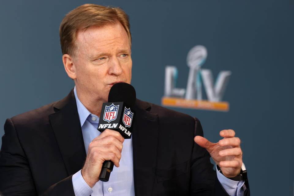 Roger Goodell with a microphone. 