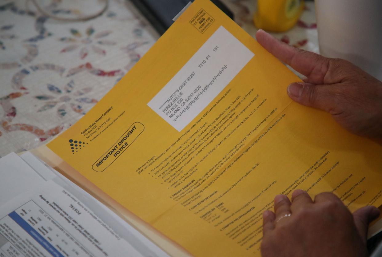 Nellie Perez keeps a careful file of bills, drought notices and others papers from the private Golden Coast Water Company. She and her neighbors in low income Niland, Calif., who already pay among the country's highest water bills, face new, double digit increases if state regulators approve the company's application. March 2, 2023.