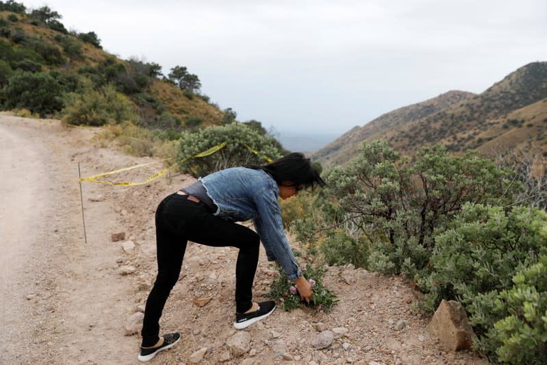 A relative of the Rhonita Miller-Lebaron and Dawna Ray Langford and their children who were killed by unknown assailants, puts flowers at the crime scene during a journey to bury the Miller-Lebaron Family near Bavispe, Sonora