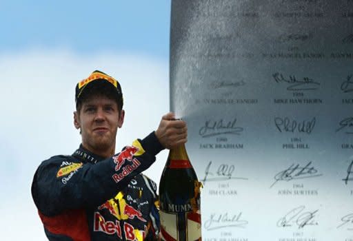 Red Bull Racing's German driver Sebastian Vettel celebrates on the podium at the Hockenheimring circuit during the German Formula One Grand Prix. Fernando Alonso extended his lead in this year's Formula One drivers' world championship on Sunday when he drove to a flawless victory for Ferrari in the German Grand Prix