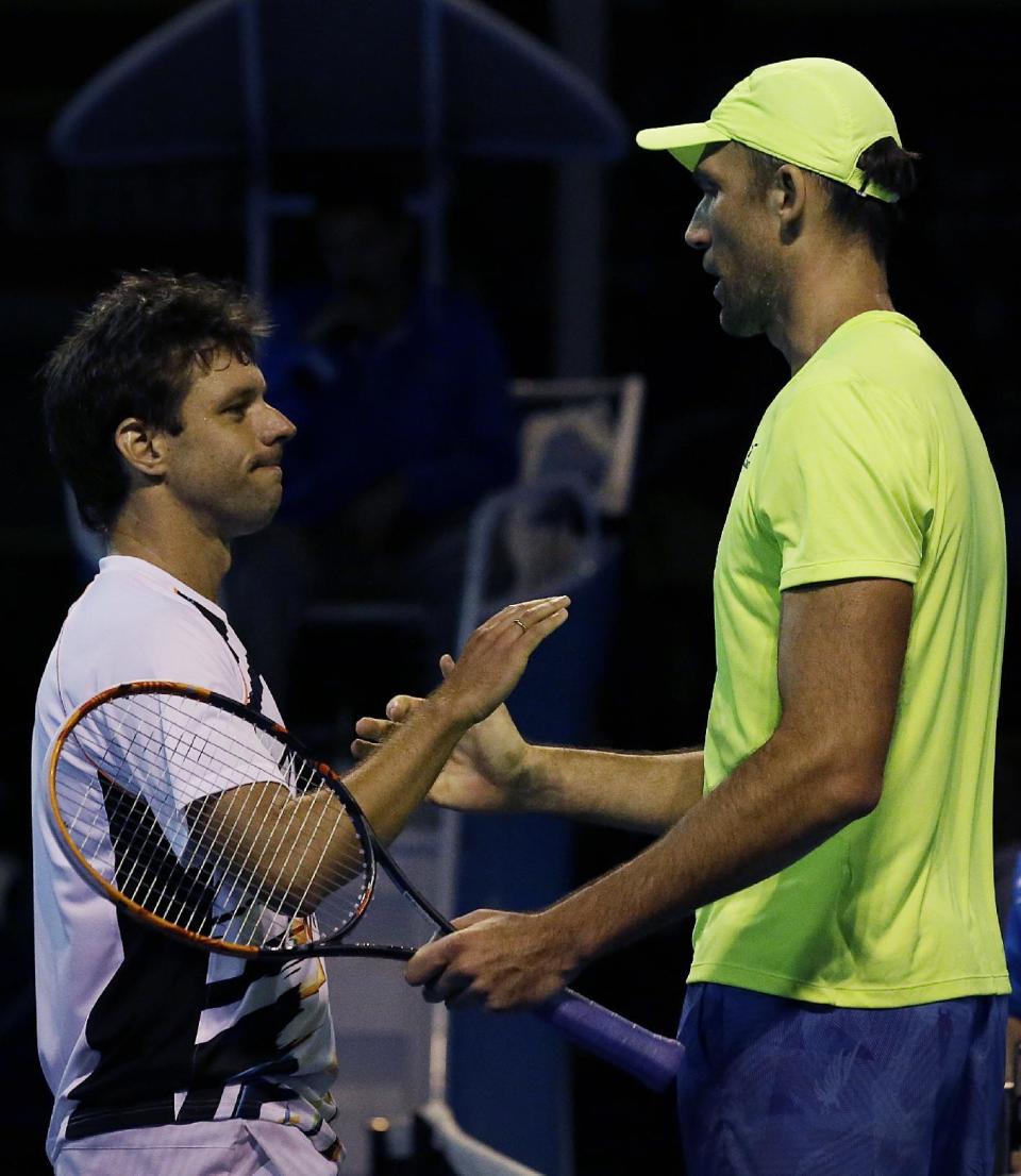 Croatia's Ivo Karlovic, right, is congratulated by Argentina's Horacio Zeballos after winning their first round match at the Australian Open tennis championships in Melbourne, Australia, Tuesday, Jan. 17, 2017. (AP Photo/Aaron Favila)
