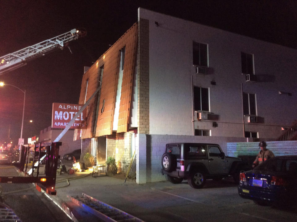 This photo provided by the Las Vegas Fire Department, firefighters work the scene of a fire at a three-story apartment complex early Saturday, Dec. 21, 2019 in Las Vegas. The fire was in first-floor unit of the Alpine Motel Apartments and its cause was under investigation, the department said. Authorities say multiple fatalities were reported and several were injured. (Las Vegas Fire Department via AP)