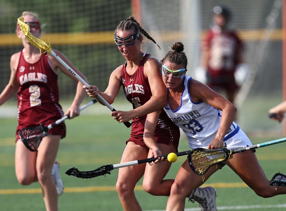 Mariemont player Caroline Soller (33) battles Bishop Watterson's Brooke Biagi for the ball during their tournament match, Wednesday, June 1, 2022.