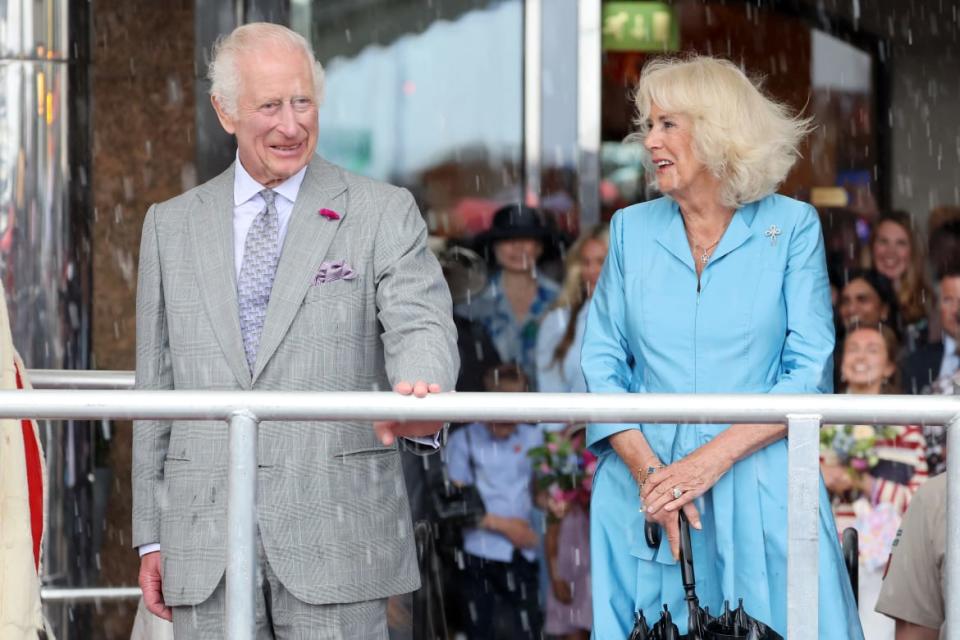 King Charles III and Queen Camilla watch The King’s Parade under torrential rain during an official visit to Jersey on July 15, 2024 in St Helier, Jersey.