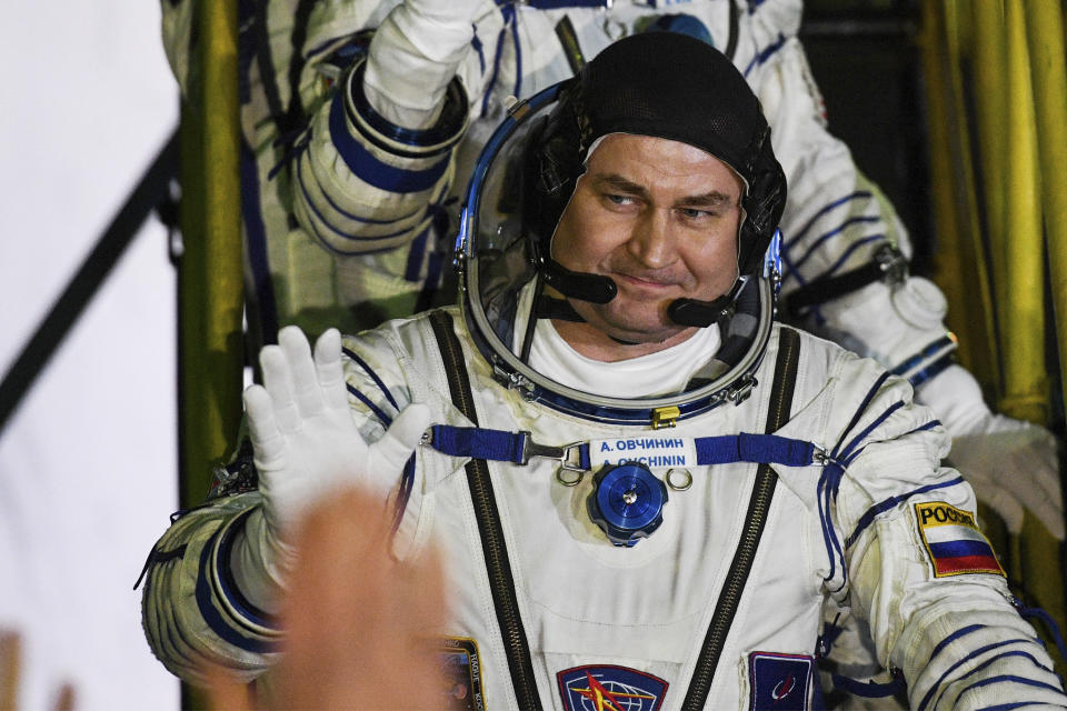 Russian cosmonaut Alexey Ovchinin, crew member of the mission to the International Space Station, ISS, waves near the rocket prior the launch of Soyuz-FG rocket at the Russian leased Baikonur cosmodrome, Kazakhstan, Thursday, March 14, 2019. (AP Photo/Kyrill Kudryavtsev, Pool)