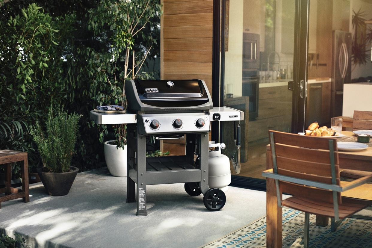  A Weber Spirit II E-310 gas grill on a patio 