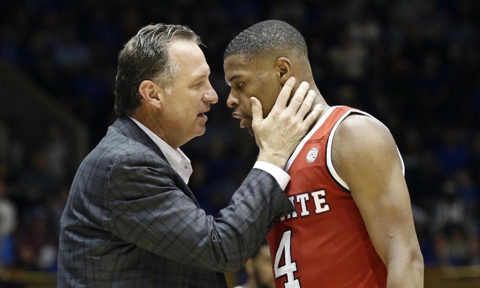 N.C. State's head coach Mark Gottfried speaks with Dennis Smith Jr. during the second half of an NCAA college basketball game in Durham, N.C., Monday, Jan. 23, 2017. North Carolina State won 84-82. (AP Photo/Gerry Broome)