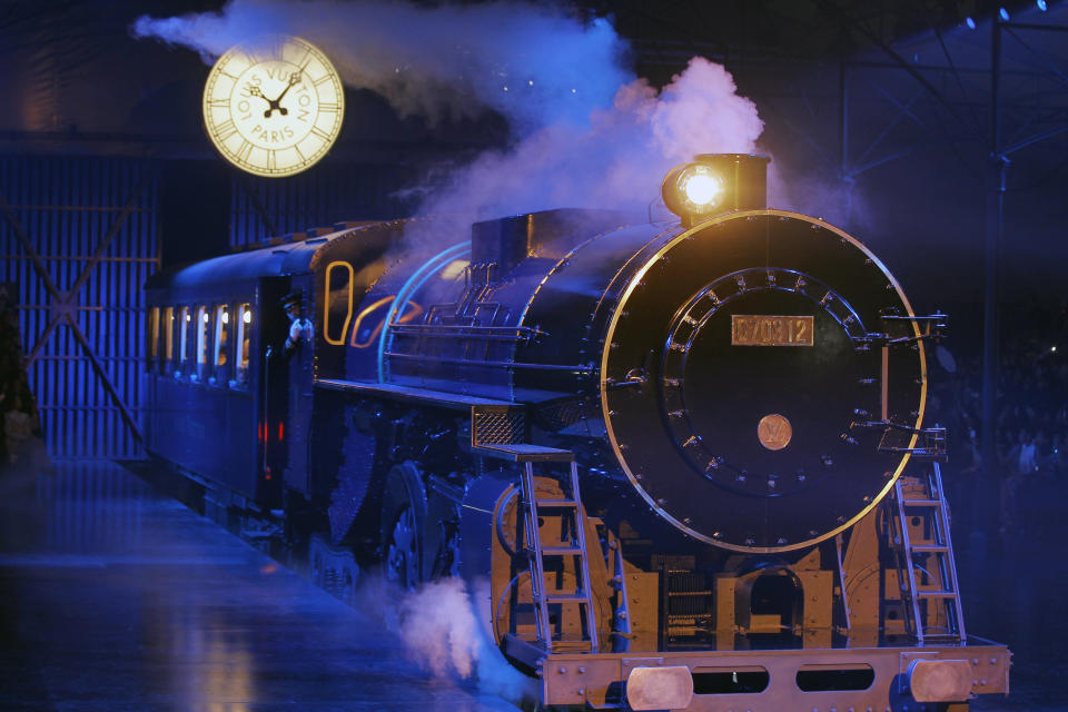 A train carrying models enters the venue prior to the presentation of the Louis Vuitton collection, Women's Fall-Winter, ready-to-wear 2013 during Paris Fashion week, Wednesday, March 7, 2012. (AP Photo/Jacques Brinon)