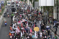 Pro-democracy supporters demonstrate through the streets of Bangkok, Thailand, Thursday, June 24, 2021. Pro-democracy demonstrators have taken to the streets of Thailand's capital again, marking the 89th anniversary of the overthrow of the country's absolute monarchy by renewing their demands that the government step down, the constitution be amended and the monarchy become more accountable. (AP Photo/Sakchai Lalit)