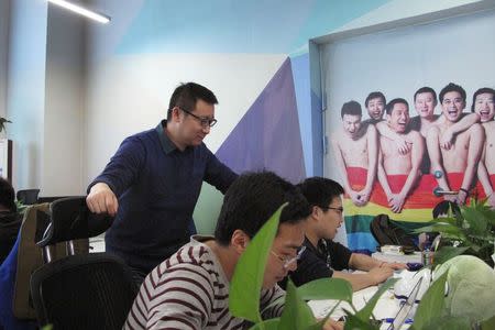 Ma Baoli, founder of Blue City, parent company of Chinese gay dating app Blued, supervises his staff at the company's office in Beijing, January 7, 2015. REUTERS/Guo Yeqi