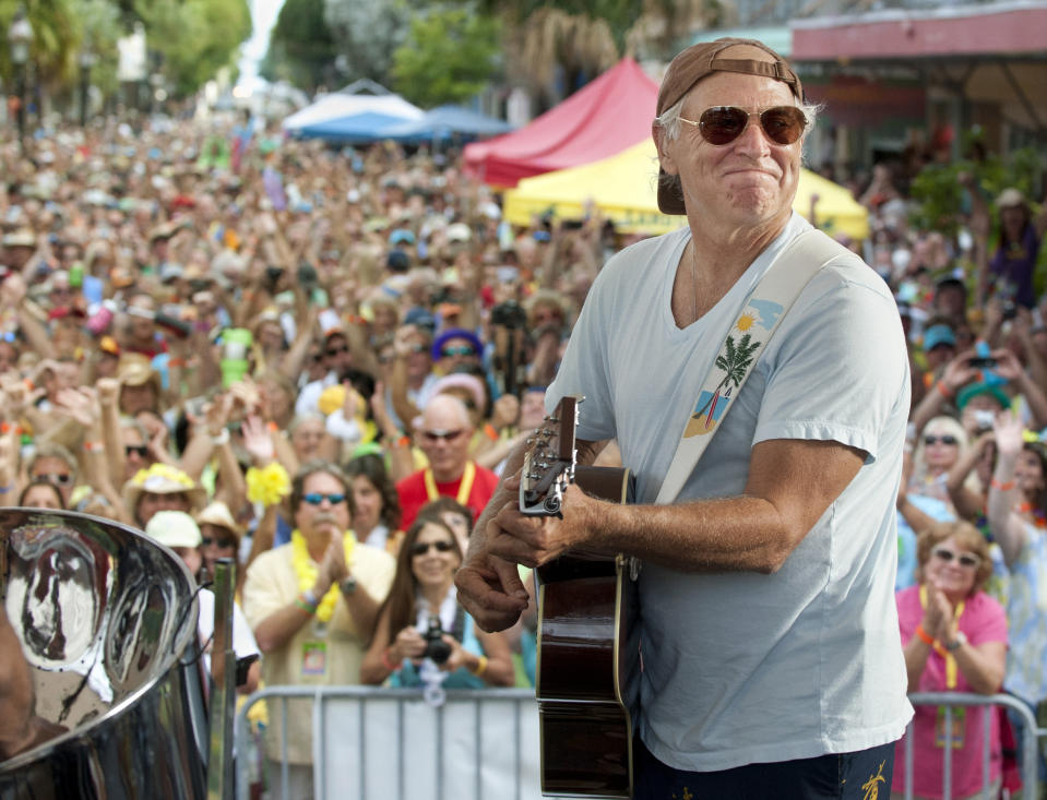 FILE- In this Nov. 4, 2011, file photo released by the Florida Keys News Bureau, singer/songwriter Jimmy Buffett performs before fans on Duval Street in Key West, Fla. Buffett, who popularized beach bum soft rock with the escapist Caribbean-flavored song “Margaritaville” and turned that celebration of loafing into an empire of restaurants, resorts and frozen concoctions, has died, Friday, Sept. 1, 2023. (Rob O'Neal/Florida Keys News Bureau via AP)