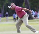 Ken Duke celebrates his birdie putt in the second round of the Zurich Classic at the TPC Louisiana course in Avondale, La., Friday, April 27, 2012. (AP Photo/Bill Haber)