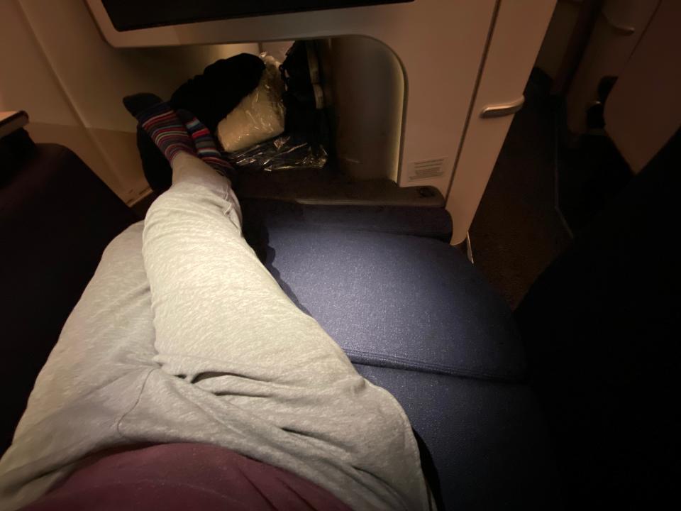 Man reclining on Finnair business class seats on flight to Bangkok freelancer photo