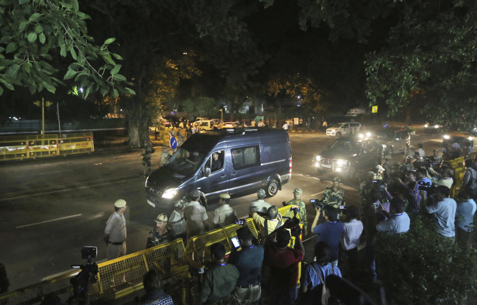 An ambulance carrying the body of former Indian prime minister Atal Bihari Vajpayee arrives at his residence in New Delhi, India, Thursday, Aug. 16, 2018. Vajpayee, a Hindu nationalist who set off a nuclear arms race with rival Pakistan but later reached across the border to begin a groundbreaking peace process, died on Thursday after a prolonged illness. He was 93. (AP Photo/Manish Swarup)