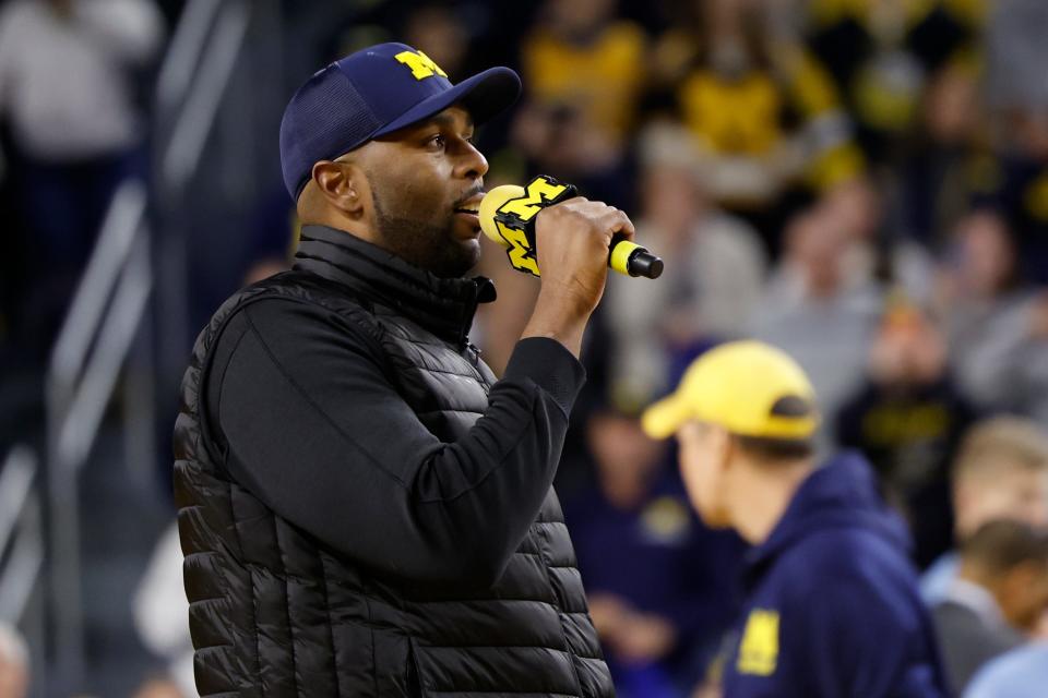 Michigan Wolverines head football coach Sherrone Moore addresses the basketball crowd during a timeout against the Iowa Hawkeyes at Crisler Center in Ann Arbor on Saturday, Jan. 27, 2024.