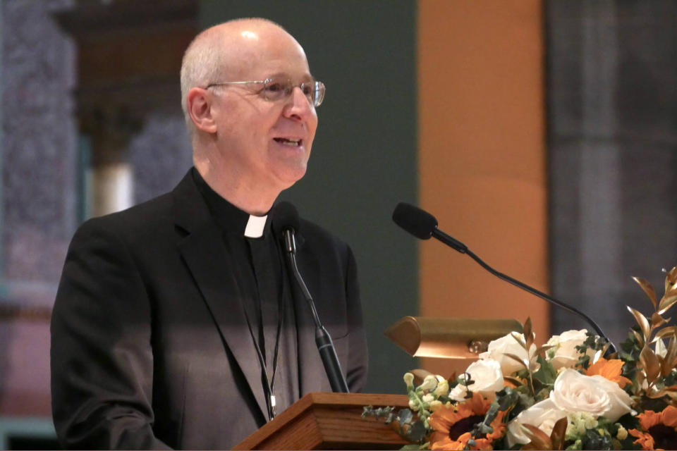 In this photo provided by America Media, the Rev. James Martin welcomes attendees to a conference sponsored by Outreach, a unique, Jesuit-run program of outreach to LGBTQ+ Catholics, at the Church of St. Paul the Apostle, in New York, June 16, 2023. Martin is the founder of Outreach. (Cristobal Spielmann/America Media via AP)