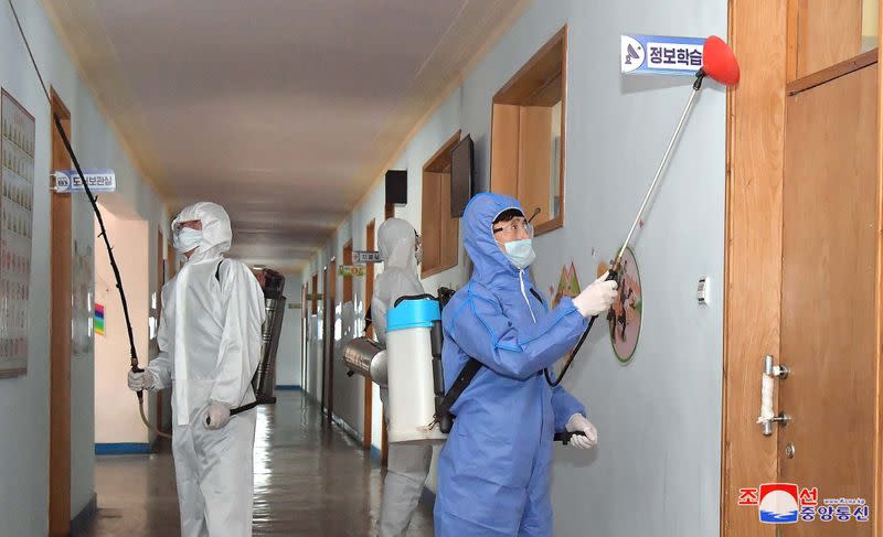 KCNA picture of volunteers carrying out disinfection work during an anti-virus campaign in Pyongyang