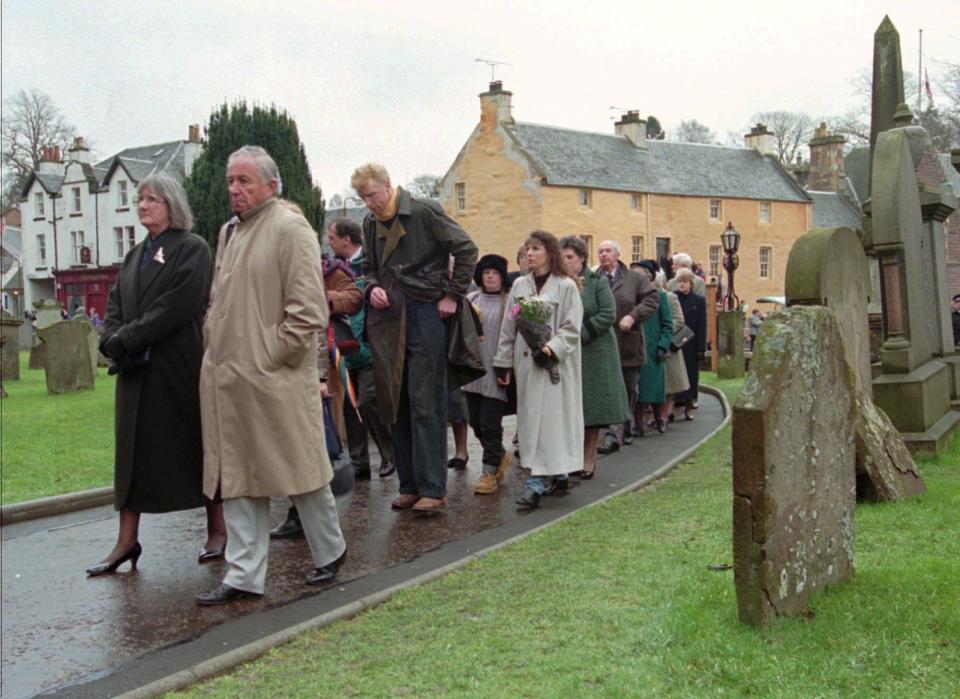 FILE - People file into Dunblane Cathedral in Dunblane, Scotland for a service, Sunday, March 17, 1996 in memory of the 16 children and one teacher who were killed during a shooting at Dunblane Primary School. A 1996 school shooting that killed 16 children in Dunblane was Britain's deadliest school shooting — and also the only one. (AP Photo/Lynne Sladky, File)