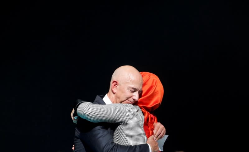 FILE PHOTO: Hatice Cengiz, fiancee of the murdered Saudi journalist Jamal Khashoggi and Jeff Bezos, founder of Amazon and Blue Origin, embrace each other as they attend a ceremony marking the first anniversary of Khashoggi's killing at the Saudi Consulate