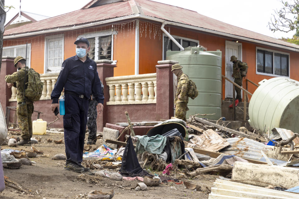 In this photo provided by the Australian Defence Force, Australian Defence Force and Department of Foreign Affairs & Trade crisis response team personnel make a damage assessment operation in Nuku'alofa, on Atata island in Tonga, following the eruption of underwater volcano, on Feb. 4, 2022. (CPL Robert Whitmore/Australian Defence Force via AP)