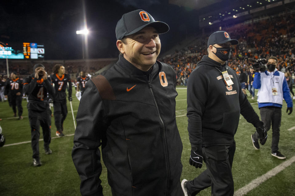 Oregon State head coach Jonathan Smith smiles as he leaves the field after an NCAA college football game against Arizona State, Saturday, Nov. 20, 2021, in Corvallis, Ore. Oregon State defeated Arizona State 24-10. (AP Photo/Andy Nelson)