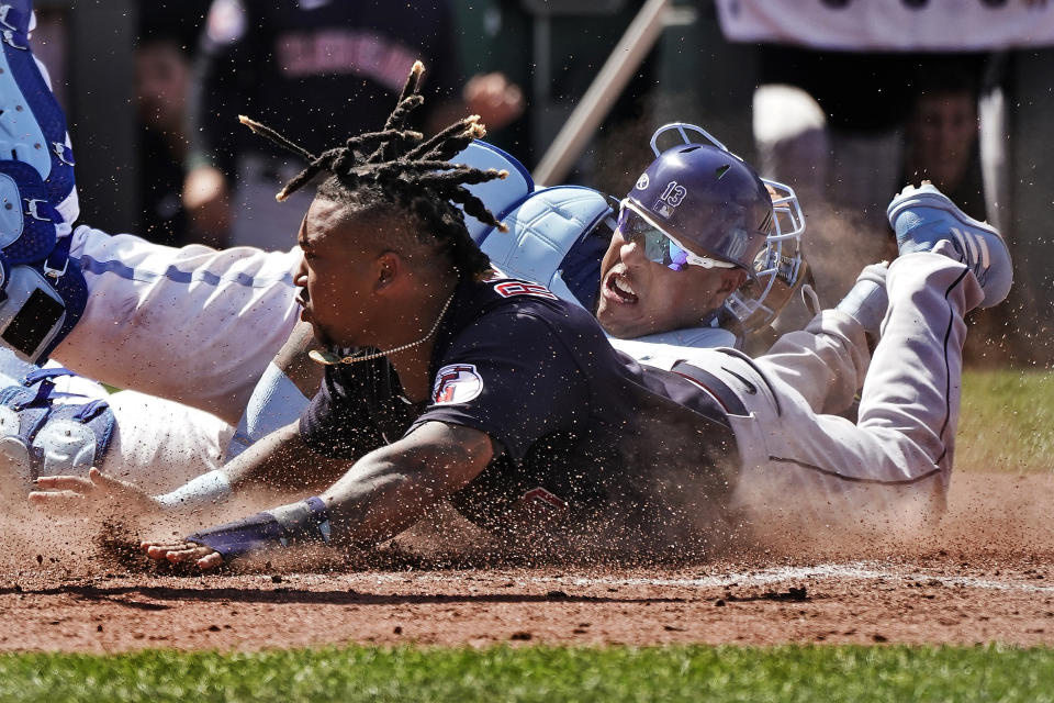 Cleveland Guardians' Jose Ramirez, front, beats the tag by Kansas City Royals catcher Salvador Perez to steal home during the tenth inning of a baseball game Thursday, June 29, 2023, in Kansas City, Mo. The Royals won 4-3 in ten innings. (AP Photo/Charlie Riedel)