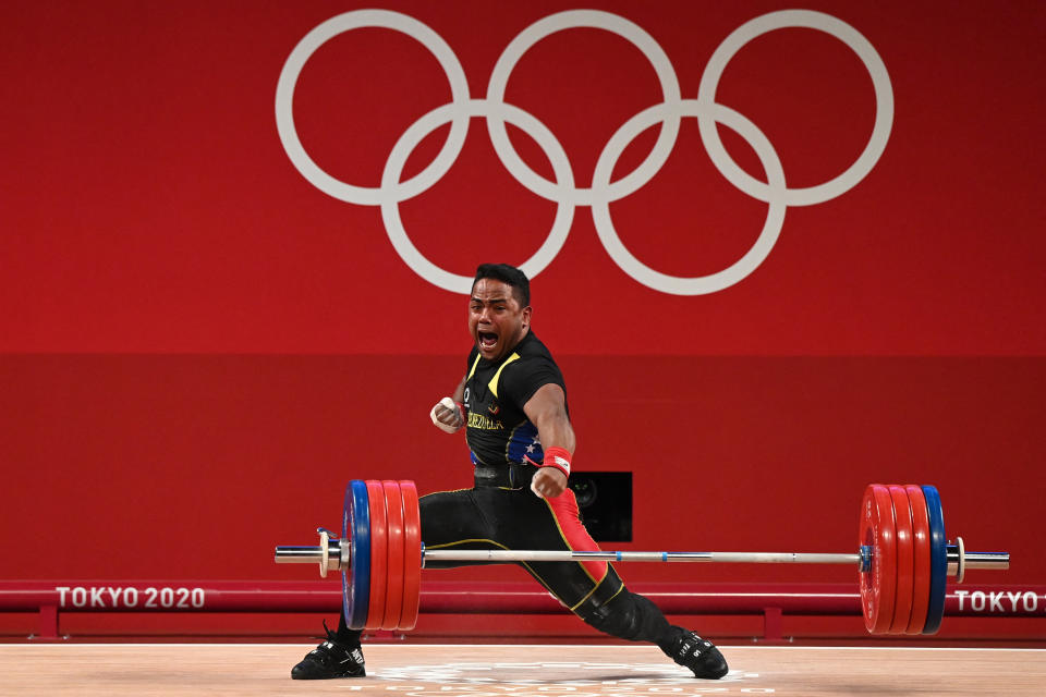 <p>Venezuela's Keydomar Giovanni Vallenilla Sanchez reacts after winning the silver medal in the men's 96kg weightlifting competition during the Tokyo 2020 Olympic Games at the Tokyo International Forum in Tokyo on July 31, 2021. (Photo by Luis ACOSTA / AFP) (Photo by LUIS ACOSTA/AFP via Getty Images)</p> 