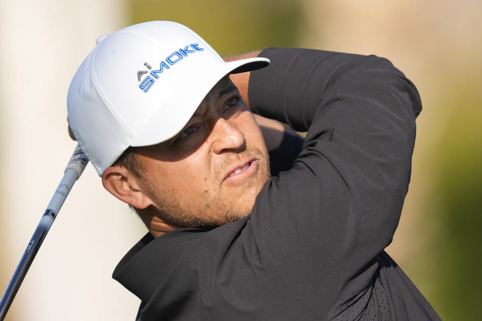 Xander Schauffele watches his tee shot on the first hole of the La Quinta Country Club course during the first round of the American Express golf tournament, Thursday, Jan. 18, 2024, in La Quinta, Calif. (AP Photo/Ryan Sun)