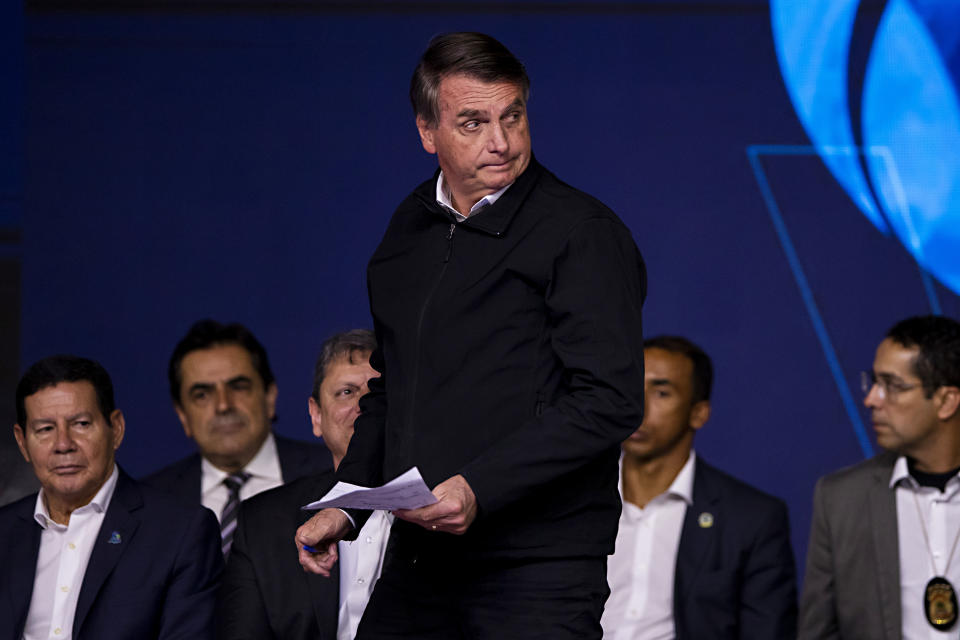 President Jair Bolsonaro gets up to speak during an event with business leaders from the poultry and pork sectors in Sao Paulo, Brazil, Tuesday, Aug. 9, 2022. (AP Photo/Marcelo Chello)