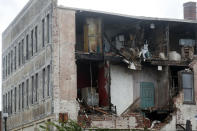 Suffolk Police survey damage to building along Saratoga Street in Suffolk, Va., after Hurricane Isaias moved through the region Tuesday morning, August 4, 2020. (Jonathon Gruenke/The Daily Press via AP)