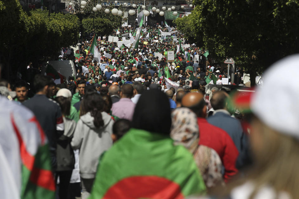 Demonstrators march during a protest in Algiers, Friday, April 26, 2019. Algerians are massing for a 10th week of protests against their country's ruling class, calling for the ex-president's brother to be put on trial. (AP Photo/Fateh Guidoum)