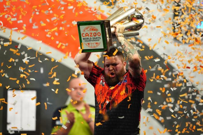 Michael Smith lifted the Sid Waddell Trophy after losing last year’s final  (PA)