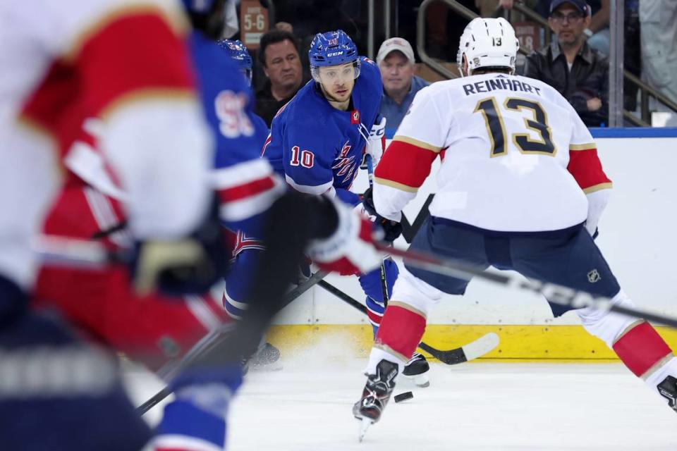 May 22, 2024; New York, New York, USA; New York Rangers left wing Artemi Panarin (10) plays the puck against Florida Panthers center Sam Reinhart (13) during the third period of game one of the Eastern Conference Final of the 2024 Stanley Cup Playoffs at Madison Square Garden. Mandatory Credit: Brad Penner-USA TODAY Sports