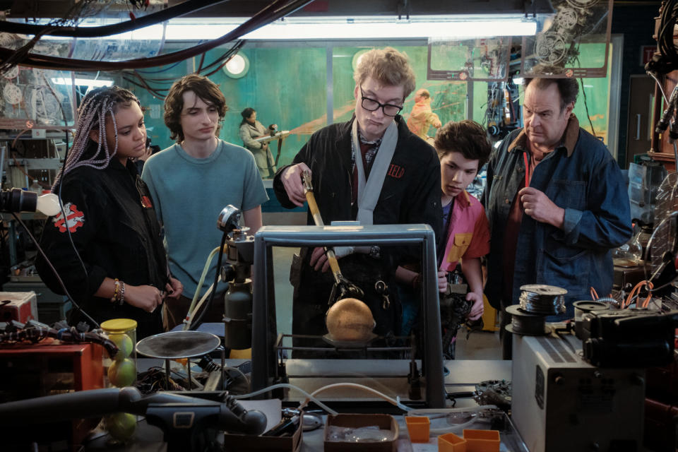 Lucky (Celeste Oâ€™Connor), Trevor (Finn Wolfhard), Lars Pinfield (James Acaster), Podcast (Logan Kim) and Ray (Dan Aykroyd) in Columbia Picturesâ€™ GHOSTBUSTERS: FROZEN EMPIRE.