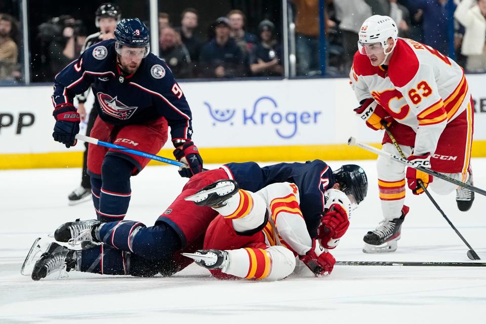 Oct 20, 2023; Columbus, Ohio, USA; Columbus Blue Jackets defenseman Erik Gudbranson (44) goes after Calgary Flames defenseman Rasmus Andersson (4) after he hit Columbus Blue Jackets right wing Patrik Laine (29) late in the third period of the NHL hockey game at Nationwide Arena. The Blue Jackets on 3-1.