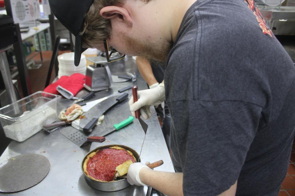 Andrew Budig makes a sausage and mushroom Chicago-style deep-dish pizza during the grand opening Oct. 20, 2023, of Pizzeria Uno in LaPorte inside the Pine Lake Resort and Banquets hotel.