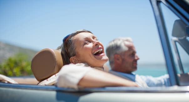 Mature couple driving in convertible