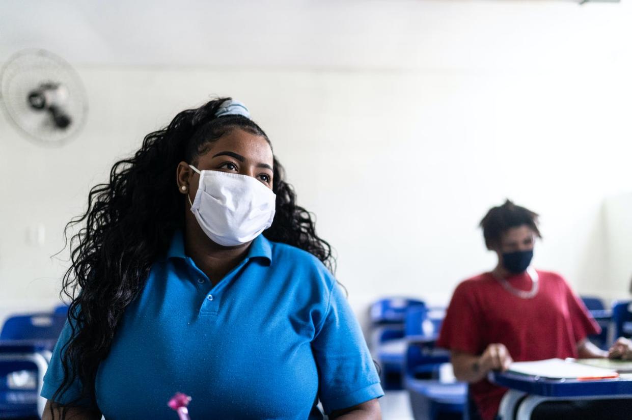 <span class="caption">'College promise' programs increase Black and Hispanic female college student enrollment the most. </span> <span class="attribution"><a class="link " href="https://www.gettyimages.com/detail/photo/university-high-school-student-wearing-face-mask-royalty-free-image/1280141107?adppopup=true" rel="nofollow noopener" target="_blank" data-ylk="slk:FG Trade/E+ via Getty Images;elm:context_link;itc:0;sec:content-canvas">FG Trade/E+ via Getty Images</a></span>