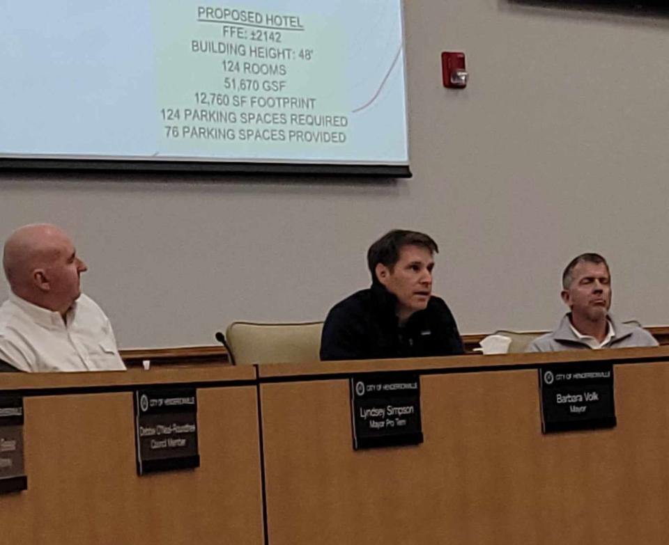 Philip Cox, center, of Mitch Cox Companies, and his team listen as residents speak during a neighborhood compatibility meeting on Jan. 29 about a proposed hotel to be built behind Blue Ridge Mall.