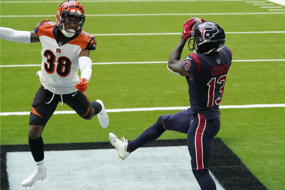 Houston Texans wide receiver Brandin Cooks (13) catches a pass for a touchdown as Cincinnati Bengals cornerback LeShaun Sims (38) defends during the first half of an NFL football game Sunday, Dec. 27, 2020, in Houston. (AP Photo/Sam Craft)