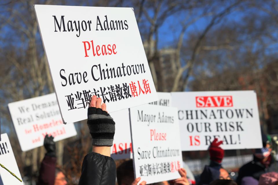 People hold signs at a February 2022 rally protesting violence against Asian-Americans at Sara D. Roosevelt Park in New York City's Chinatown neighborhood. The rally took place in the wake of the murder of 35-year old Christina Yuna Lee, who was stabbed to death in her apartment by a man who followed her into her building. Attacks on Asian-Americans rose amid the COVID-19 pandemic, fueled by anti-Asian rhetoric.