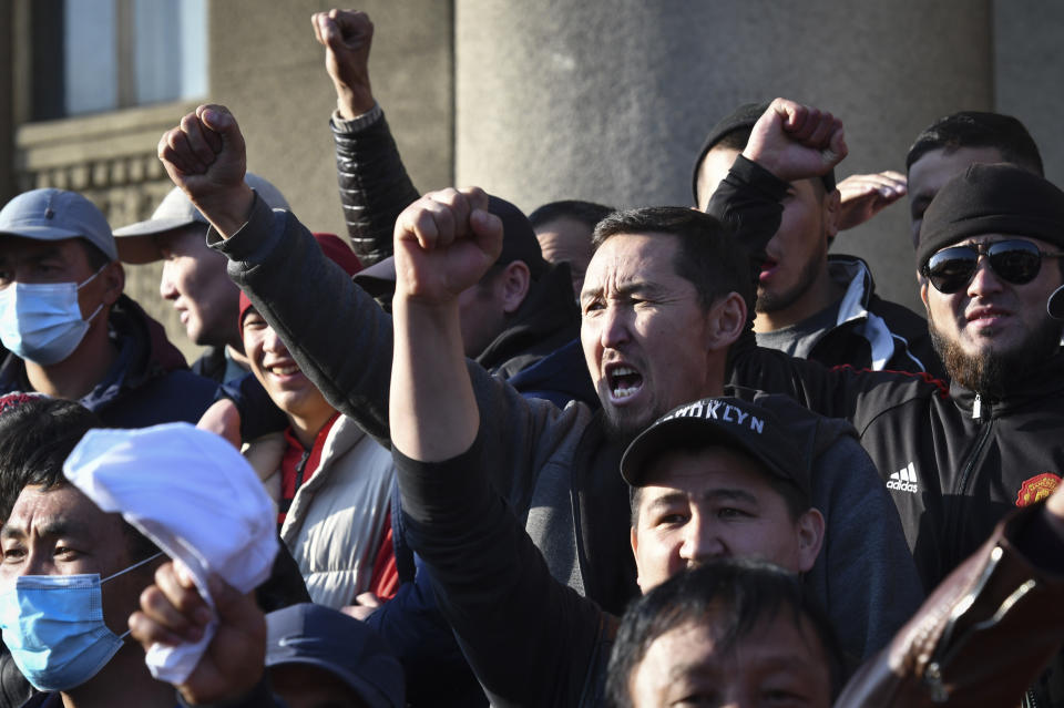 People protest during a rally on the central square in Bishkek, Kyrgyzstan, Wednesday, Oct. 7, 2020. Officials in Kyrgyzstan have nullified the results of a weekend parliamentary election after mass protests erupted in the capital of Bishkek and other cities, with opposition supporters seizing government buildings and demanding a new vote. (AP Photo/Vladimir Voronin)