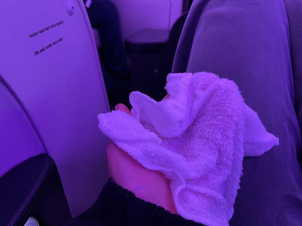 The author received a steamed towel while sitting in business class.