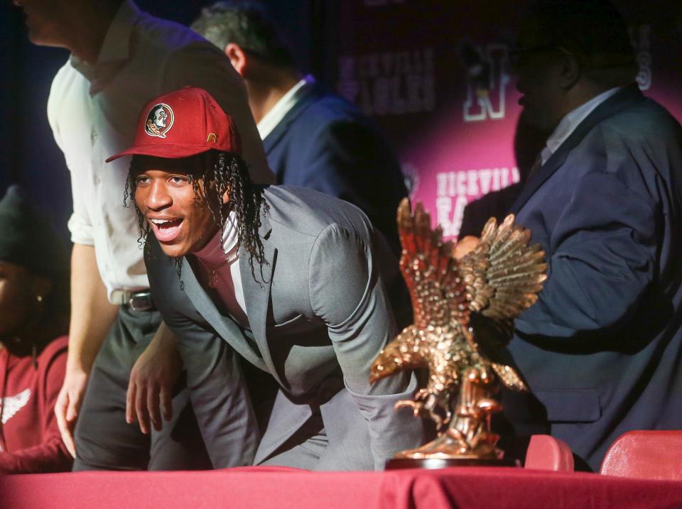 Azareyeh Thomas peers into the audience after he signs with Florida State University during the major fall football signing day event at Niceville High School.