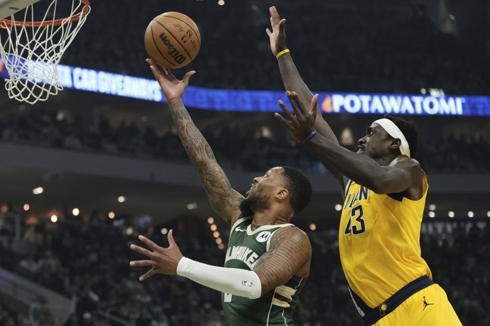 Indiana Pacers' Pascal Siakam blocks the shot of Milwaukee Bucks' Damian Lillard during the first half of Game 1 of the NBA playoff basketball game Sunday, April 21, 2024, in Milwaukee. (AP Photo/Morry Gash)