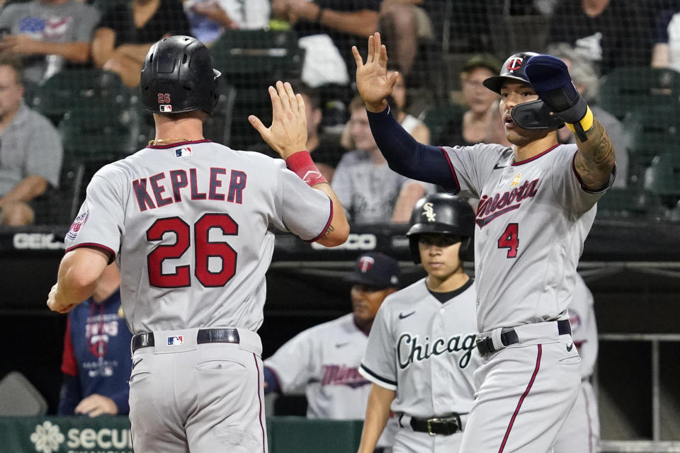 Minnesota Twins' Max Kepler, left, celebrates with Carlos Correa after scoring on a two-run double by Nick Gordon during the first inning of the team's baseball game against the Chicago White Sox, in Chicago, Friday, Sept. 2, 2022. (AP Photo/Nam Y. Huh)